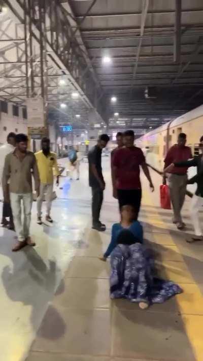 A girl dancing at a railway station