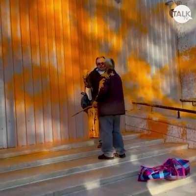 Bystander had enough of the protesters who vandalize artwork and buildings with paint, so he intervenes and covers the protester in his own paint