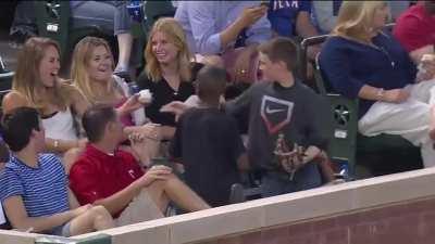 Boy gives baseball to girl