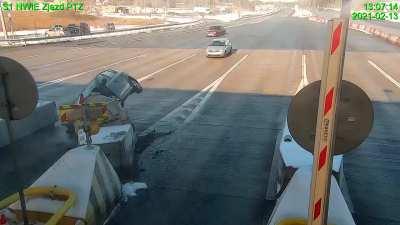 Idiot speeds past a driver slowing down for the toll booth and slams into a crash barrier