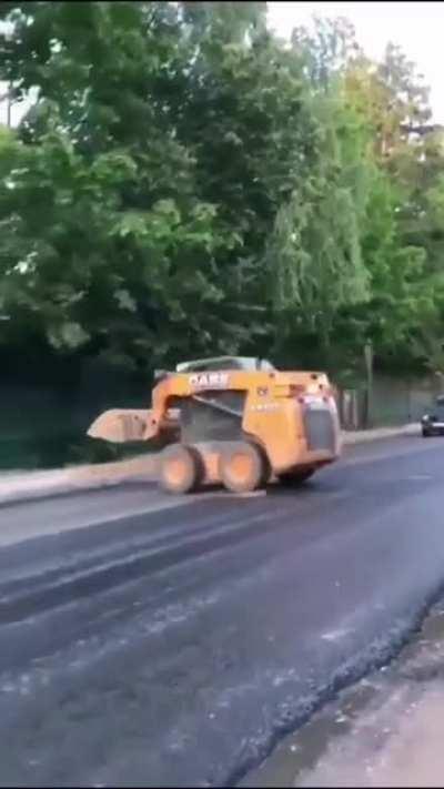 This front-end loader driver has amazing skills while dealing with traffic.