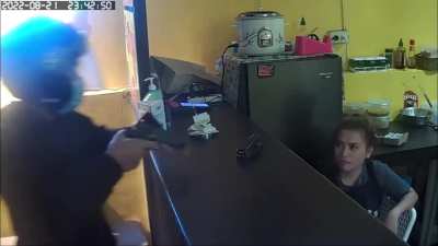 A woman smirked at the robber.