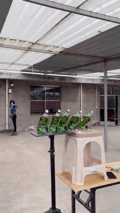 Girl/woman/idk slingshottin some beer caps