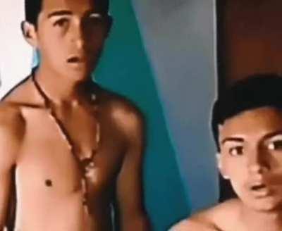 Two young Peruvian men were desperately trying to find a camera on the friends' bed. Look at their surprise when they find out it was on the wall all along!