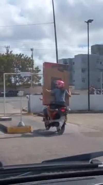 Carrying a TV on a motorbike 