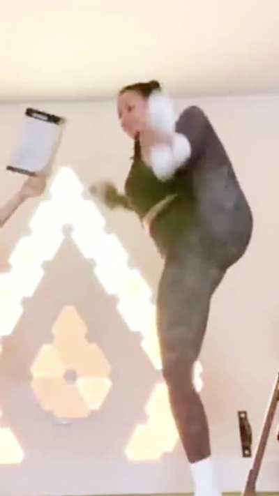 Liza Koshy stretching for a workout