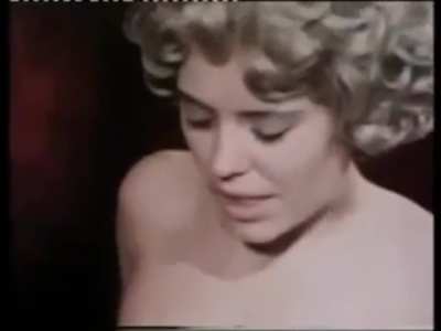 Patricia teasing a guy's cock in a scene from Hexy L' Amour 