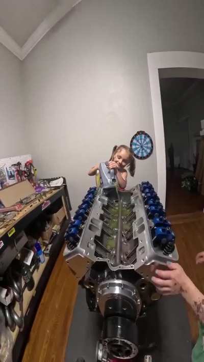 Two little girls helping their dad build an engine🤯