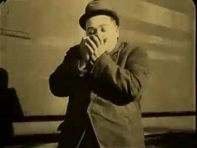 Fatty Arbuckle rolling a cig and striking the match off a moving train (1918)