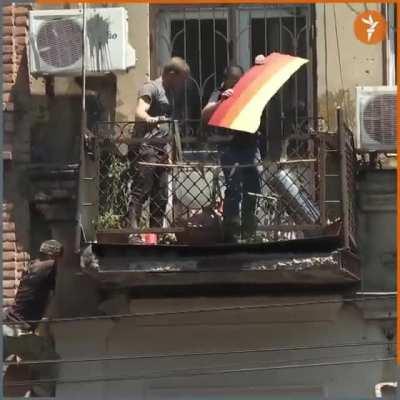 Raiders climb balcony to destroy pride flag. (JOKE: Companies in July)