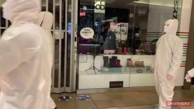 Masked people dressed in white storms a Toronto mall to protest COVID vaccines 😷
