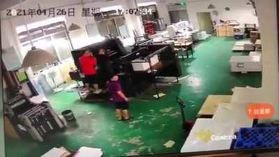 Young man gets his arm sucked into a printing press machine.