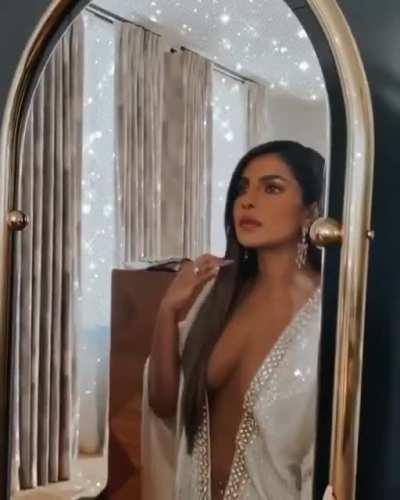 Priyanka Chopra admiring her dress one more time before taking it off for you