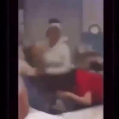 two girls jump a teacher