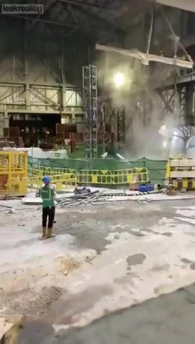 An improperly balanced excavator falls into an access hole during highway construction in Kowloon, Hong Kong on October 15th, 2020