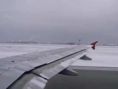 Taking off with snow covered wings
