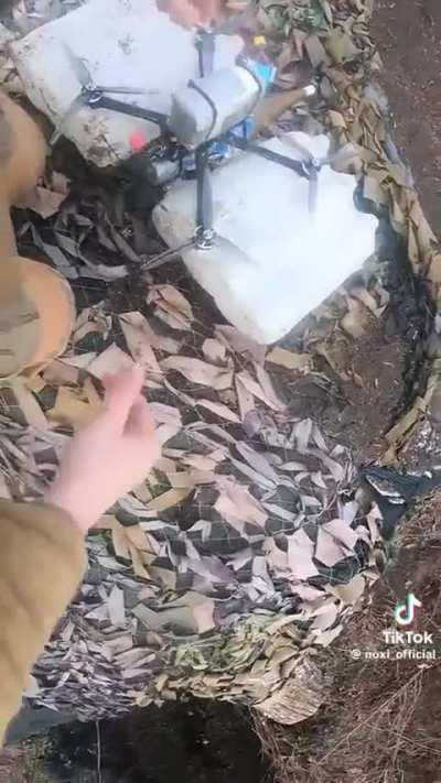 Drone being fitted with large battery and RPG warhead (music from source)