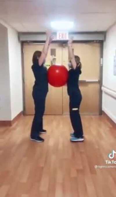 Health Care Workers With A Big Red Ball