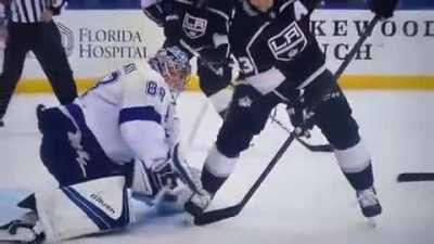 Lightning Goaltender Andrei Vasilevskiy looks between his opponent's legs to locate puck and make behind the back glove save
