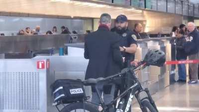 Man at SFO intl airport starts screaming. Spits at police and starts daring them to break his leg.
