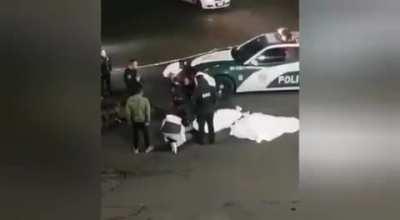 Some kids run a red light on a motorscooter.