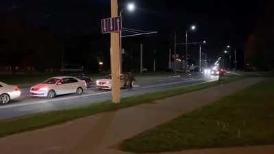 Man escapes riot police by getting into a taxi, which drives away instantly