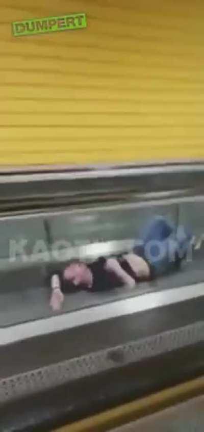 Man recieves heimlich maneuver from escalator