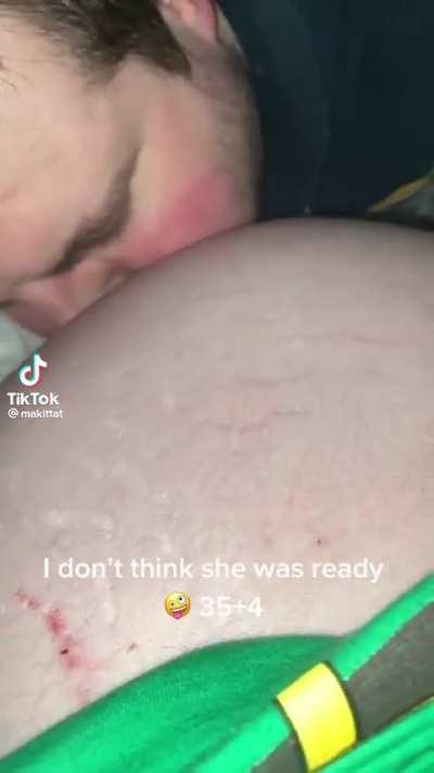 Blowing raspberries on pregnant belly 