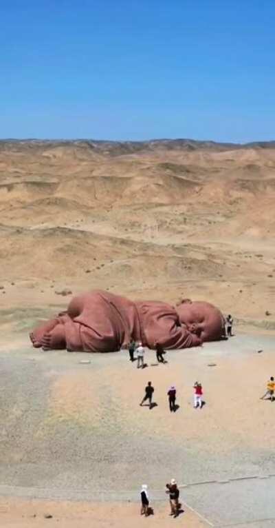 Huge baby sculpture in the Chinese desert