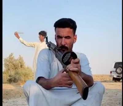 Open a bottle of water by AK-47.