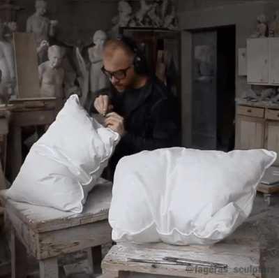 This guy sculpts stone into realistic pillows.