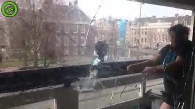 Swinging a baseball bat on a small balcony goes as well as you'd expect.