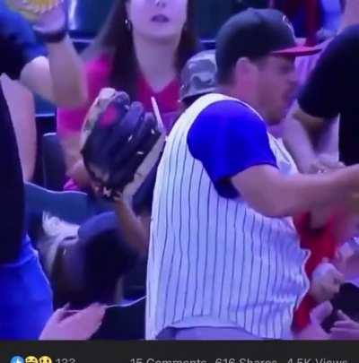 Releasing the baby that he is holding for 1 second to catch a baseball while holding a beer in the other hand