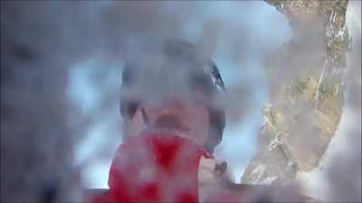 Snowboarder Falls Off Rocky Cliff