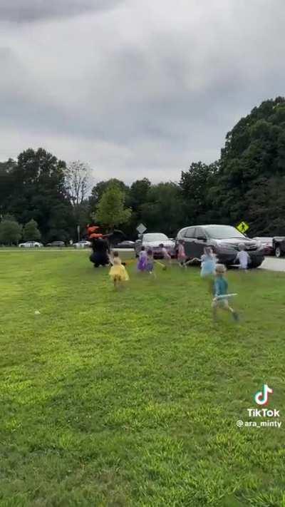 Swarm of little girls fighting a dragon
