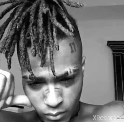 X playing with his cheek