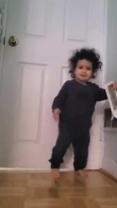 Kid makes self dizzy, bumps into wall and then proceeds to throw plastic object at father recording