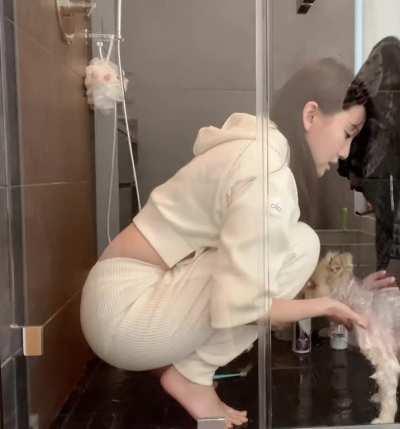 Aria squatting down in her shower