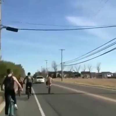Pulling wheelies on a busy road.