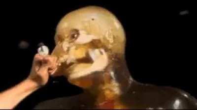 Man fighting a dummy with knitting needles.