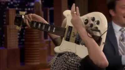 Cara Delevingne Plays Sweet Home Alabama On A Guitar Behind Her Head.