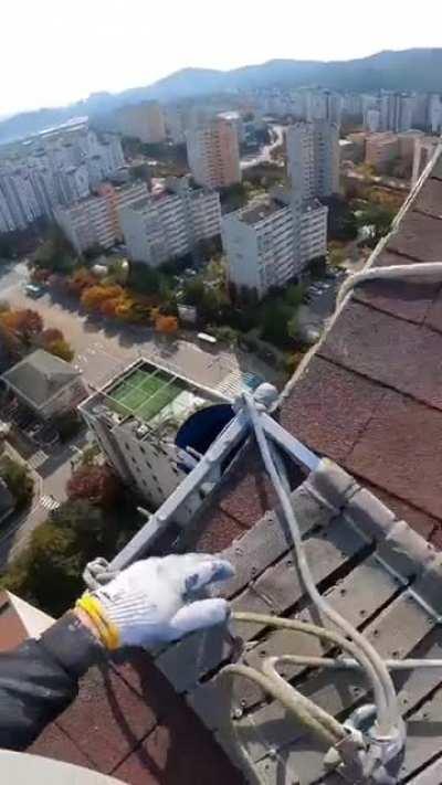 Painting the side of a building.