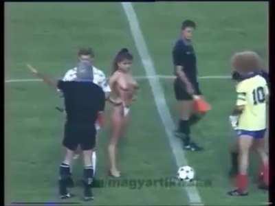 1990, A topless woman ceremonially kicks off a match between Hungary and Colombia to celebrate the fall of communism and the liberation of women in Hungary.