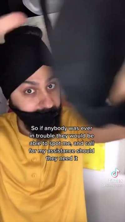 Sikh man discusses the spiritual significance of his hair while he ties it in front of the camera