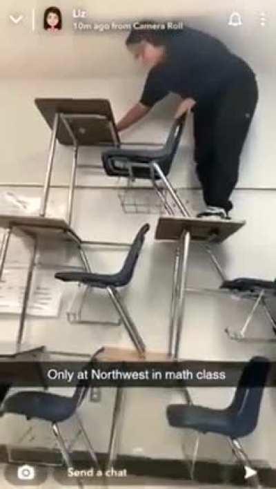 Climbing on top of a tower of desks