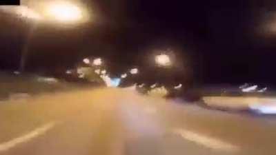 Motorcyclist races car on the highway and ends up crashing