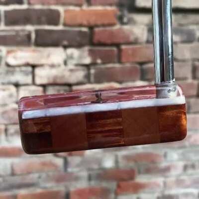 My client wanted to make a putter for his mason brother. I found some doll house bricks and a mini trowel, created a wood base to match a Crick level, and poured white acrylic as the mortar. Then clear acrylic over everything.