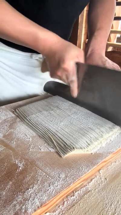 Chef cutting soba noodles