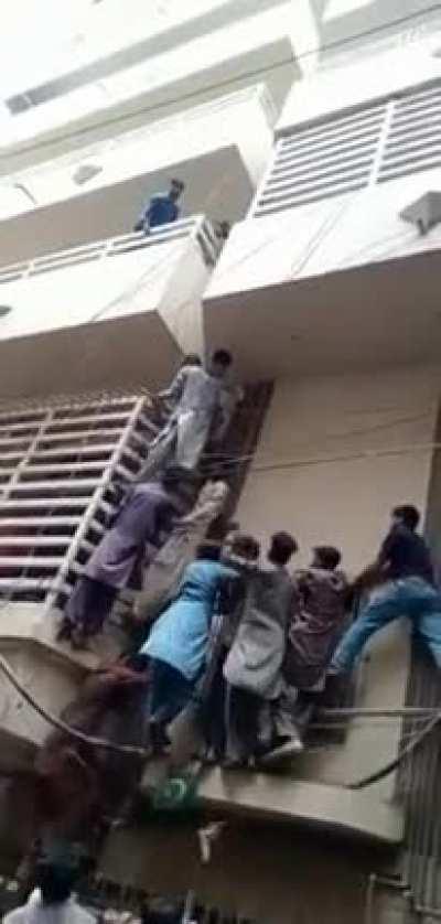 Mob charging at a man for alleged blasphemy. This looks like that scene from world war z