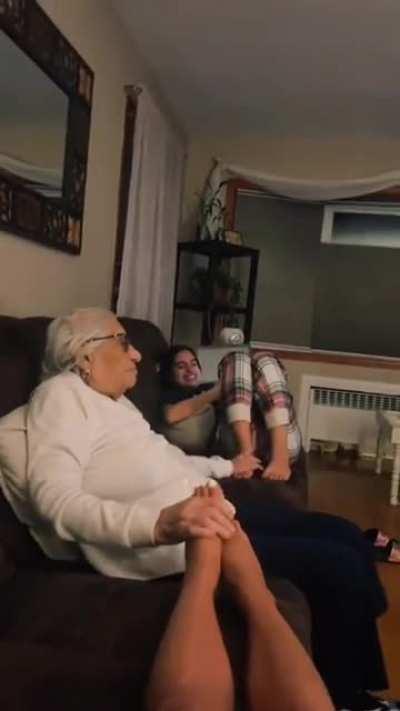 Grandma plays with granddaughters' feet